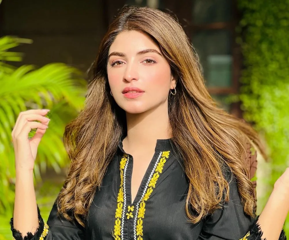Kinza Hashmi pic in black dress with green plants, Behind the Scenes: Kinza Hashmi's First Drama Salary Exposed!